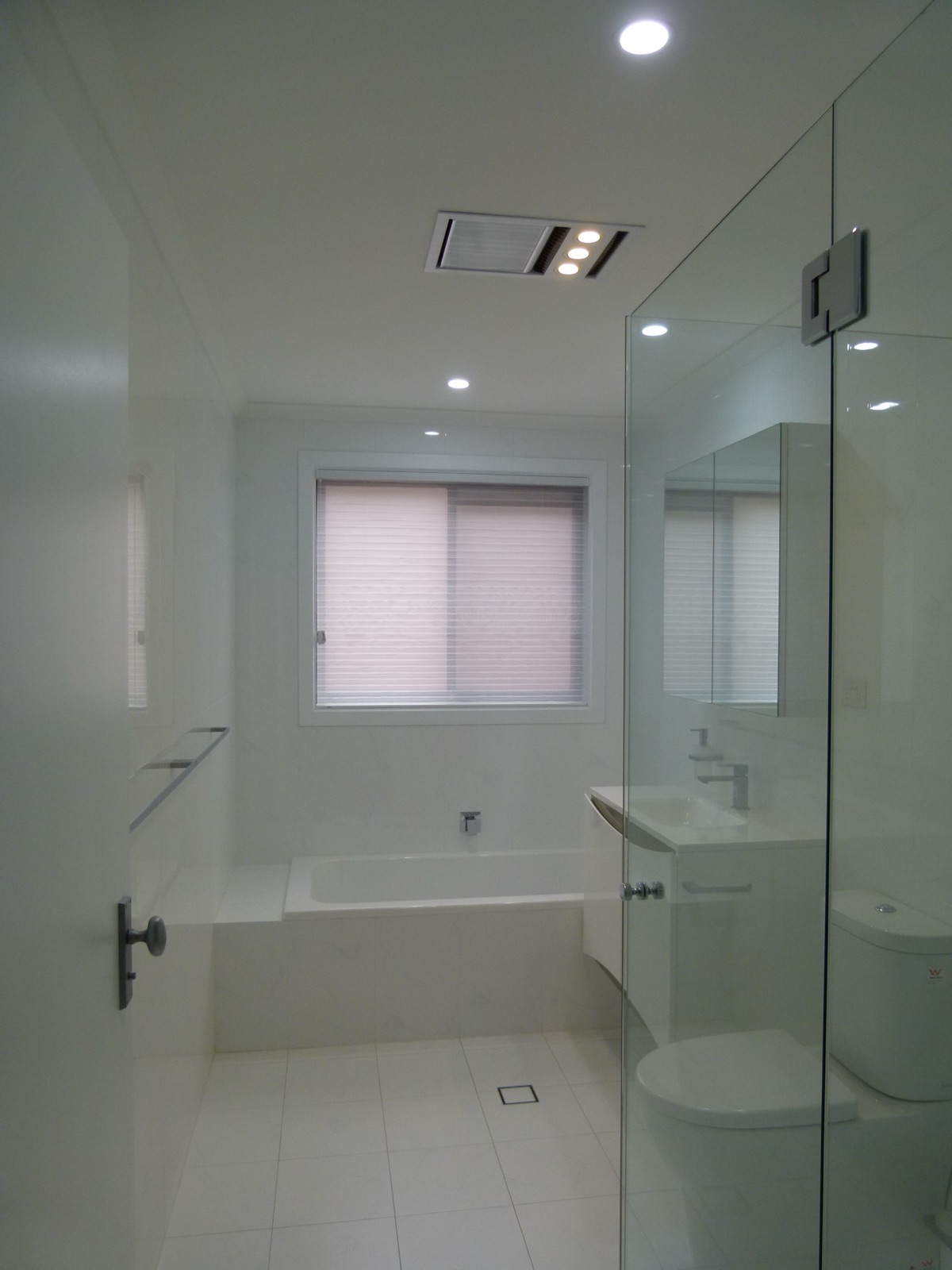 Full bathroom renovation with a built-in bath and frameless glass shower